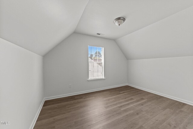 620 Hanska Way, Raleigh, NC 27610 - bonus room featuring lofted ceiling, baseboards, and wood finished floors