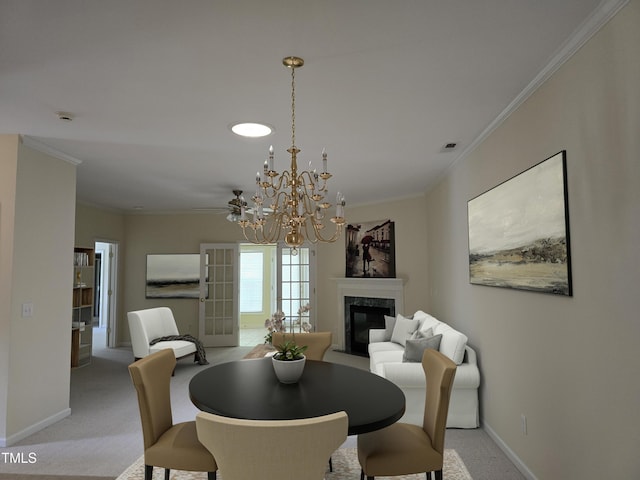 2565 Bent Green St, Raleigh, NC 27614 - dining space with crown molding, a high end fireplace, light carpet, and a chandelier