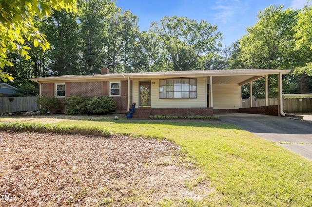 ranch-style home featuring driveway, brick siding, fence, a front lawn, and an attached carport