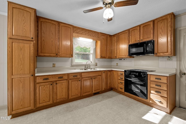 kitchen featuring brown cabinets, a ceiling fan, black appliances, and light countertops