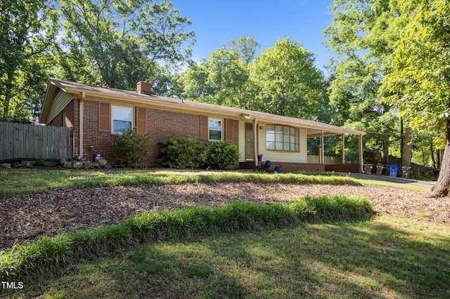 ranch-style home featuring brick siding, fence, a front yard, and a chimney