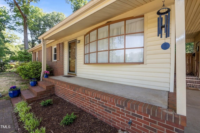 view of exterior entry with covered porch