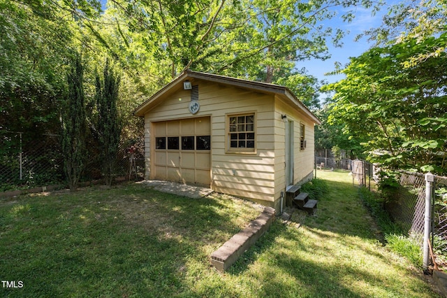 detached garage featuring fence