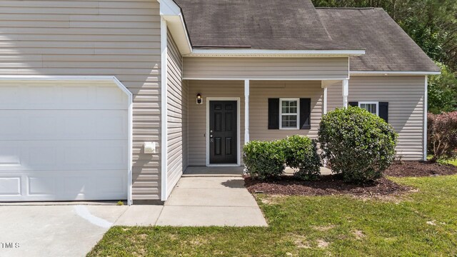 633 Prickly Pear Dr, Fuquay Varina, NC 27526 - property entrance with a shingled roof, a porch, and an attached garage
