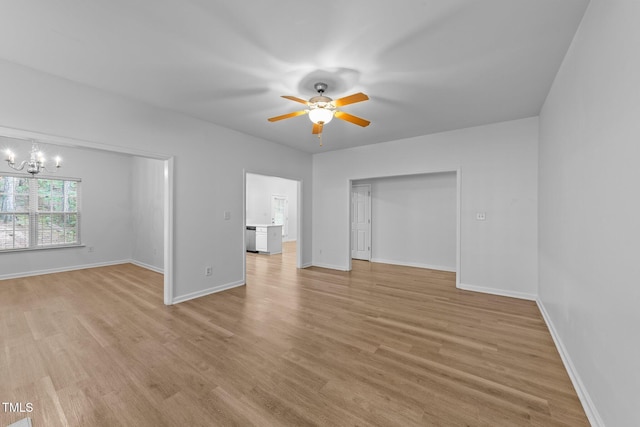 633 Prickly Pear Dr, Fuquay Varina, NC 27526 - unfurnished living room with a chandelier, a ceiling fan, light wood-style flooring, and baseboards