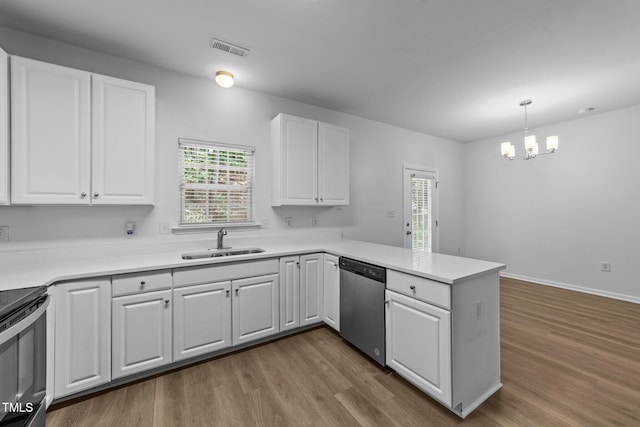 633 Prickly Pear Dr, Fuquay Varina, NC 27526 - kitchen with dishwasher, a sink, a peninsula, dark wood-style floors, and white cabinetry