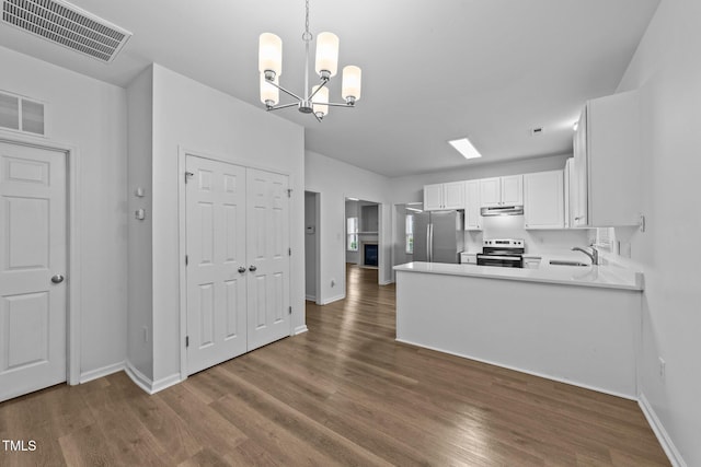 633 Prickly Pear Dr, Fuquay Varina, NC 27526 - kitchen featuring appliances with stainless steel finishes, a sink, under cabinet range hood, a chandelier, and dark wood-type flooring