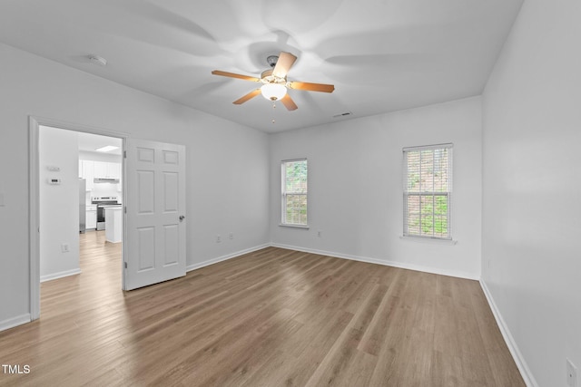 633 Prickly Pear Dr, Fuquay Varina, NC 27526 - empty room with wood finished floors, a ceiling fan, and baseboards