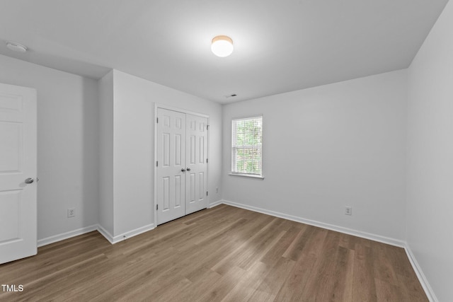 633 Prickly Pear Dr, Fuquay Varina, NC 27526 - unfurnished bedroom with wood finished floors, baseboards, and a closet