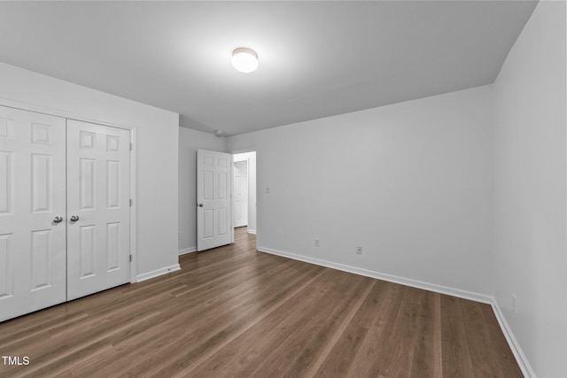 633 Prickly Pear Dr, Fuquay Varina, NC 27526 - unfurnished bedroom featuring baseboards, wood finished floors, and a closet