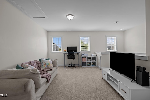 living room featuring baseboards, visible vents, attic access, and light colored carpet