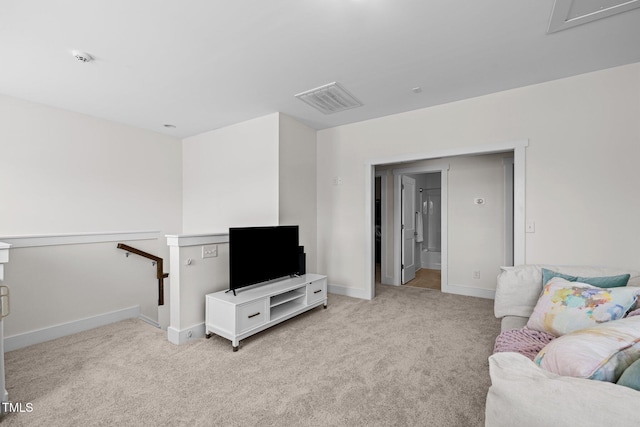 living room featuring baseboards, light colored carpet, and visible vents