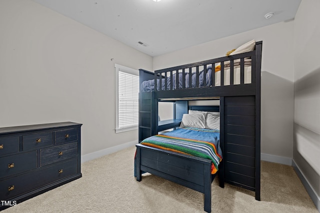 bedroom with baseboards, carpet flooring, and visible vents