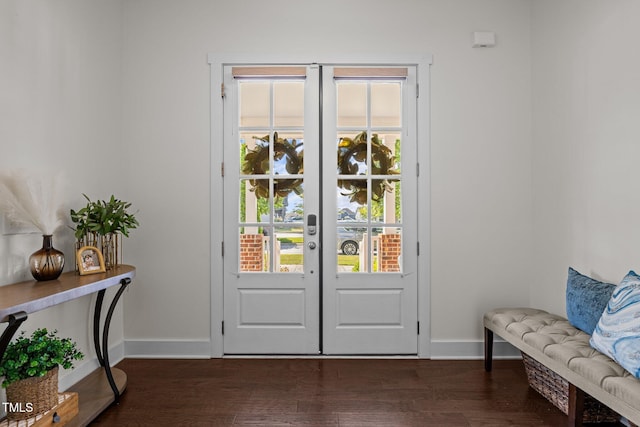 doorway to outside featuring baseboards and dark wood-style floors