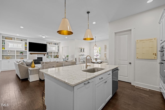 kitchen with visible vents, a sink, dark wood-type flooring, and dishwasher