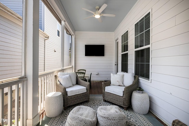 sunroom / solarium featuring ceiling fan