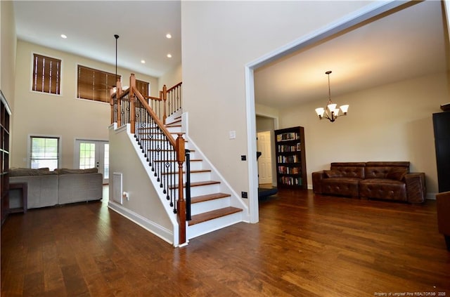 6226 Deerstand Rd, Wade, NC 28395 - stairs with wood finished floors, a chandelier, baseboards, recessed lighting, and a high ceiling