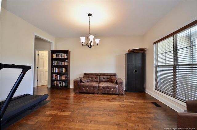 6226 Deerstand Rd, Wade, NC 28395 - living area with a chandelier, wood finished floors, and baseboards