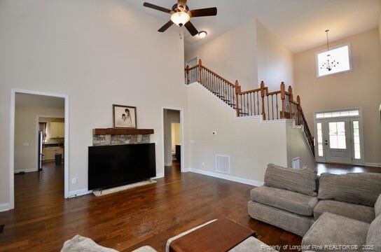6226 Deerstand Rd, Wade, NC 28395 - living room with a towering ceiling, stairs, wood finished floors, baseboards, and ceiling fan