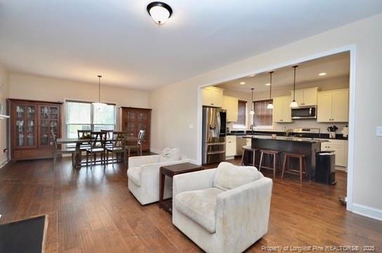 6226 Deerstand Rd, Wade, NC 28395 - living room featuring dark wood-style floors, baseboards, and recessed lighting