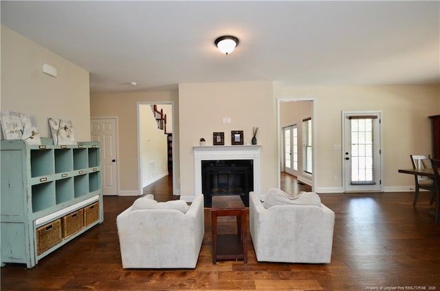 6226 Deerstand Rd, Wade, NC 28395 - living room with a glass covered fireplace, dark wood-style floors, and baseboards