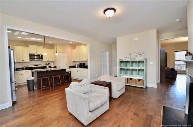 6226 Deerstand Rd, Wade, NC 28395 - living room featuring dark wood-type flooring, recessed lighting, and baseboards