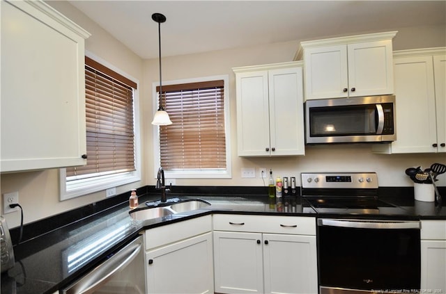 6226 Deerstand Rd, Wade, NC 28395 - kitchen with appliances with stainless steel finishes, a sink, dark countertops, white cabinetry, and pendant lighting
