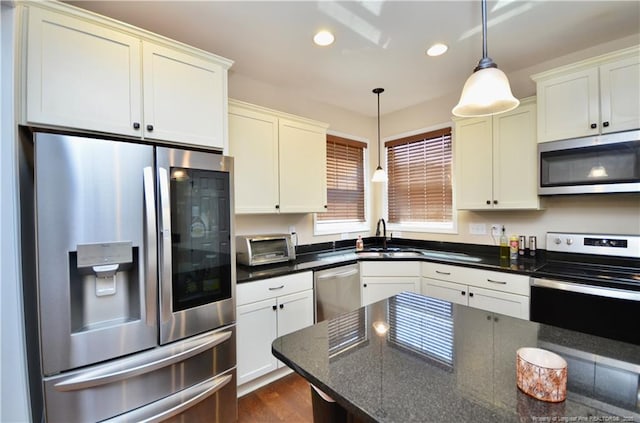 6226 Deerstand Rd, Wade, NC 28395 - kitchen featuring appliances with stainless steel finishes, a sink, decorative light fixtures, recessed lighting, and white cabinetry