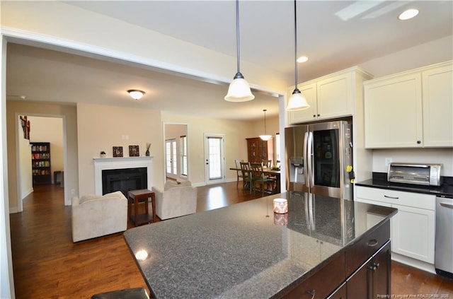 6226 Deerstand Rd, Wade, NC 28395 - kitchen featuring appliances with stainless steel finishes, dark wood finished floors, white cabinets, recessed lighting, and a kitchen island