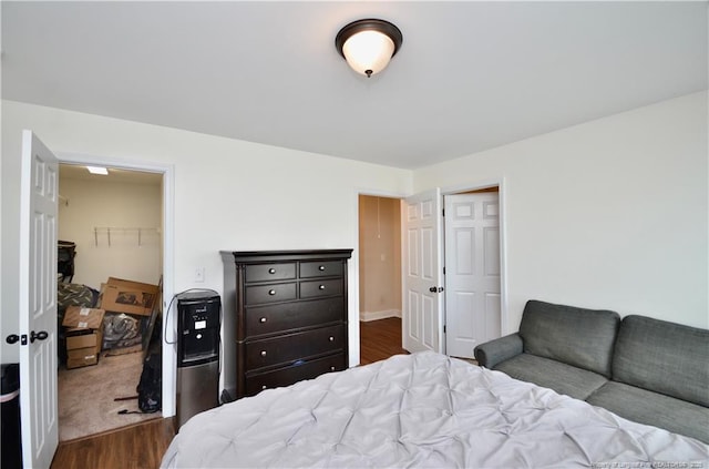6226 Deerstand Rd, Wade, NC 28395 - bedroom with dark wood-style floors, a closet, and a spacious closet