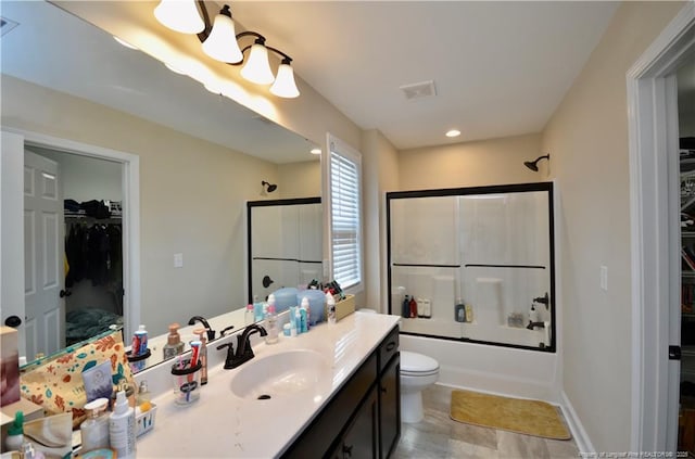 6226 Deerstand Rd, Wade, NC 28395 - bathroom with vanity, shower / bath combination with glass door, toilet, and a walk in closet
