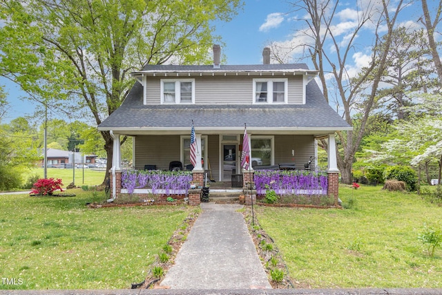 303 Wilcox St, Warrenton, NC 27589 - view of front of home with covered porch, a front lawn, and roof with shingles