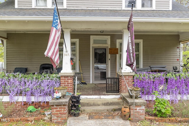 303 Wilcox St, Warrenton, NC 27589 - doorway to property featuring covered porch and a shingled roof