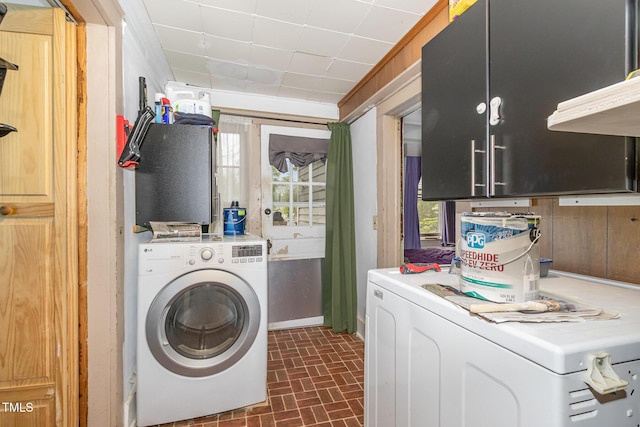 303 Wilcox St, Warrenton, NC 27589 - laundry area featuring washer / dryer and brick patterned floors