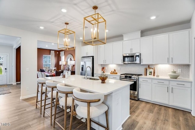 1248 Hardin Hill Ln, Knightdale, NC 27545 - kitchen featuring stainless steel appliances, a sink, recessed lighting, decorative backsplash, and an island with sink