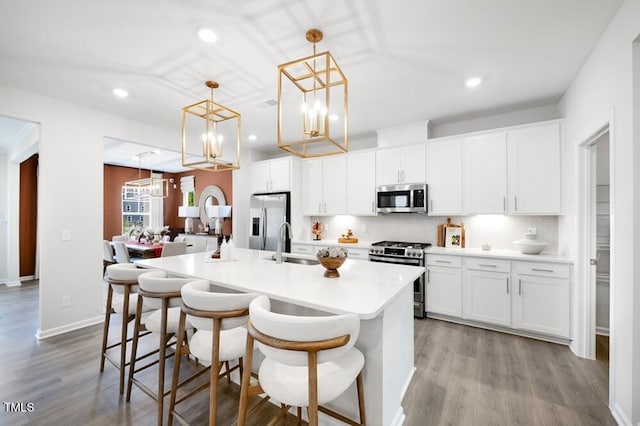 1248 Hardin Hill Ln, Knightdale, NC 27545 - kitchen featuring a sink, decorative backsplash, an island with sink, appliances with stainless steel finishes, and recessed lighting