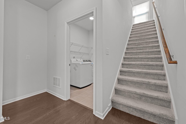 1047 Aberlour Ln, Burlington, NC 27215 - stairway with separate washer and dryer, baseboards, wood finished floors, and visible vents