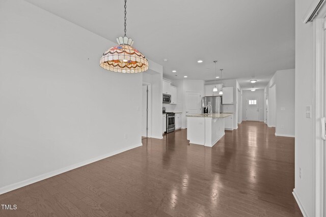 1047 Aberlour Ln, Burlington, NC 27215 - unfurnished living room featuring dark wood-type flooring, baseboards, and recessed lighting