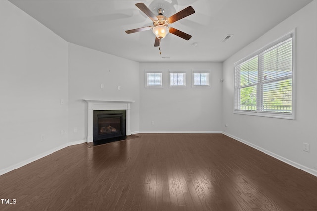 1047 Aberlour Ln, Burlington, NC 27215 - unfurnished living room featuring a fireplace with flush hearth, dark wood finished floors, baseboards, visible vents, and ceiling fan