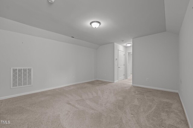1047 Aberlour Ln, Burlington, NC 27215 - additional living space featuring lofted ceiling, light carpet, baseboards, and visible vents