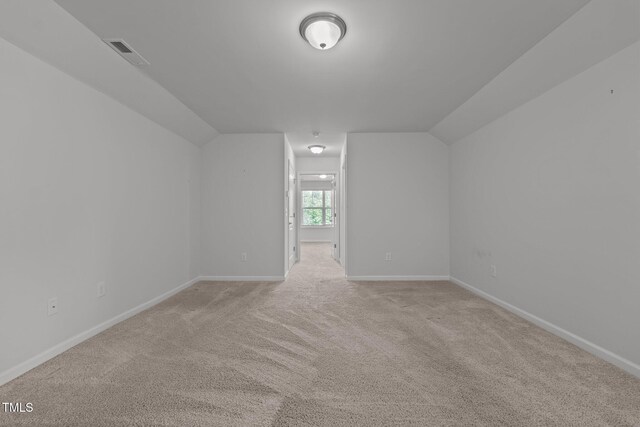 1047 Aberlour Ln, Burlington, NC 27215 - additional living space with light colored carpet, lofted ceiling, and visible vents