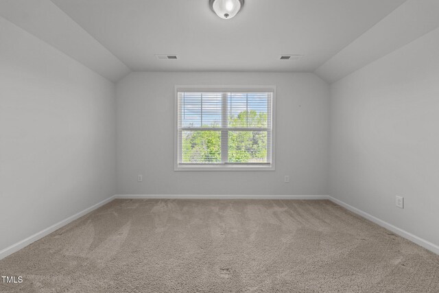 1047 Aberlour Ln, Burlington, NC 27215 - carpeted spare room featuring vaulted ceiling, visible vents, and baseboards