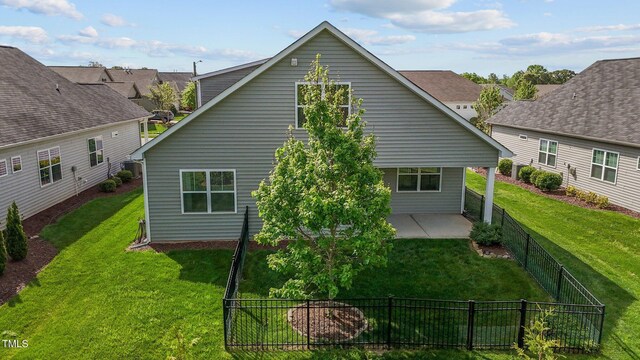 1047 Aberlour Ln, Burlington, NC 27215 - rear view of house featuring a fenced backyard, a patio area, and a lawn