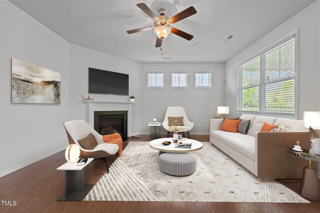 1047 Aberlour Ln, Burlington, NC 27215 - living room with a fireplace with flush hearth, baseboards, visible vents, wood finished floors, and ceiling fan