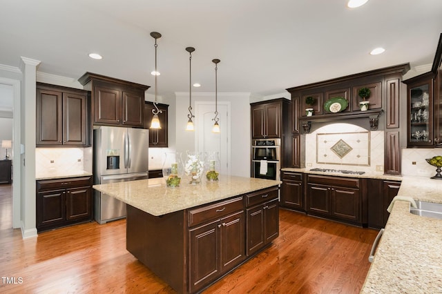 kitchen with dark brown cabinets, appliances with stainless steel finishes, and tasteful backsplash