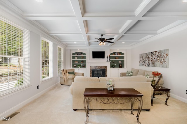 living room featuring baseboards, ceiling fan, a fireplace, and light colored carpet