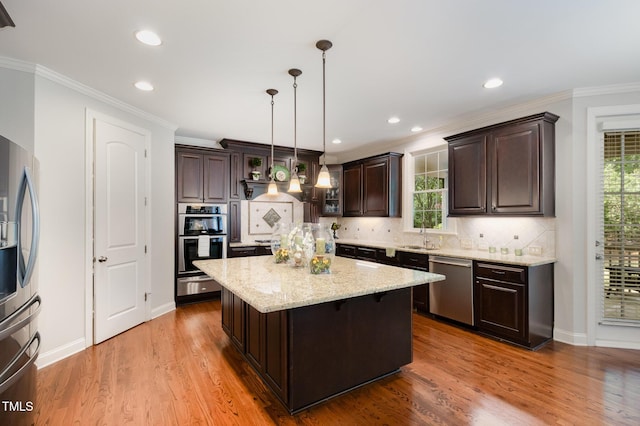 kitchen with dark brown cabinetry, light stone countertops, tasteful backsplash, a warming drawer, and stainless steel appliances