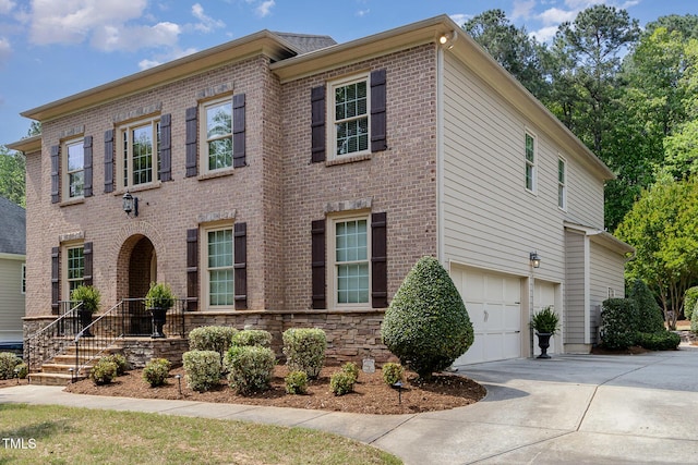 view of front of house featuring brick siding, a garage, and concrete driveway