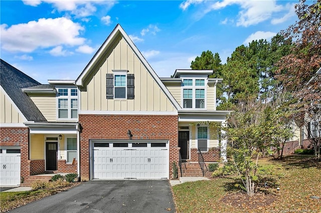 view of front facade with driveway, board and batten siding, brick siding, and a garage