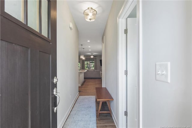 interior space featuring recessed lighting, wood finished floors, and baseboards